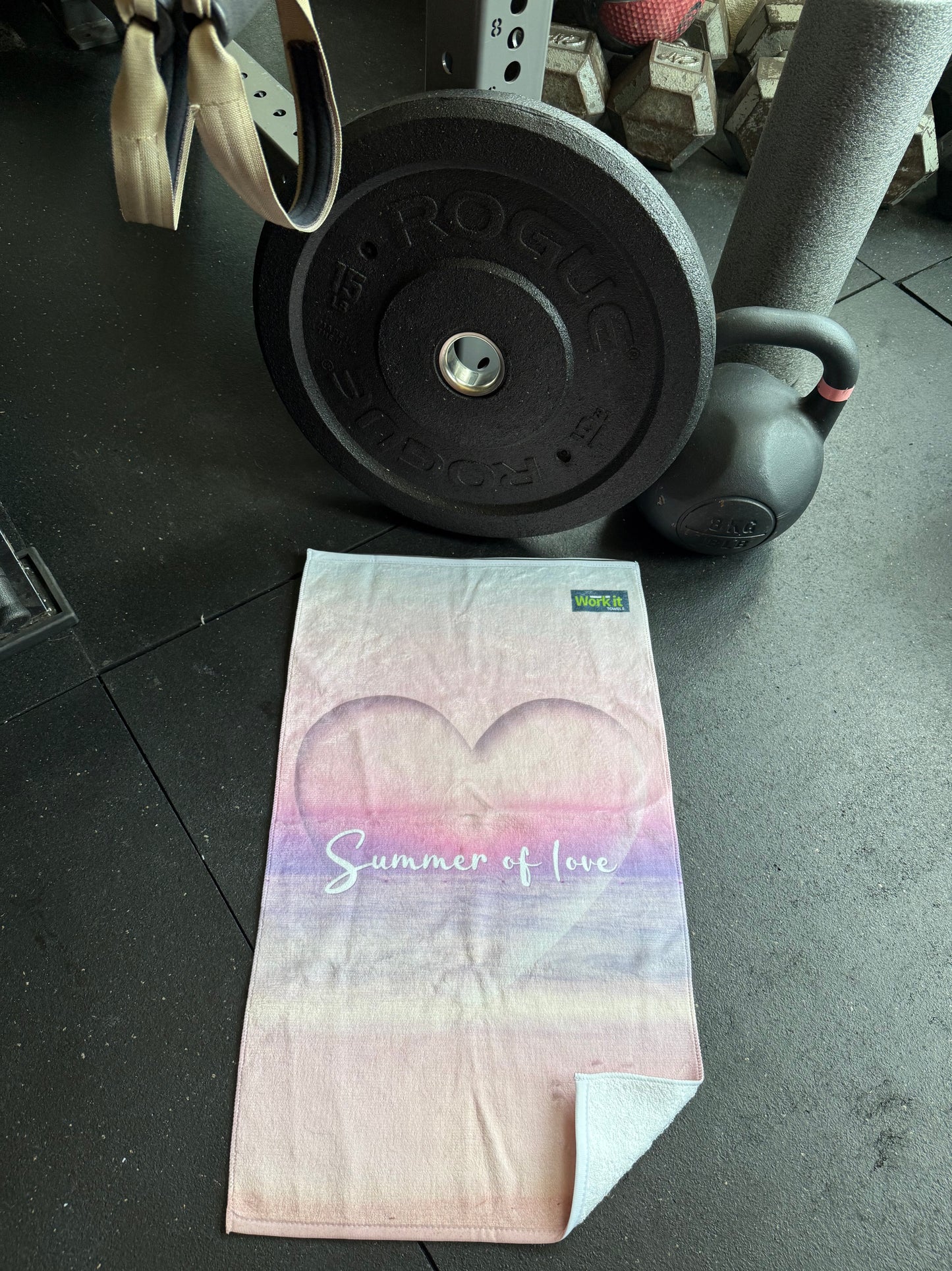 Gym towel with floral design on a gym floor next to weights for summer reality tv lovers