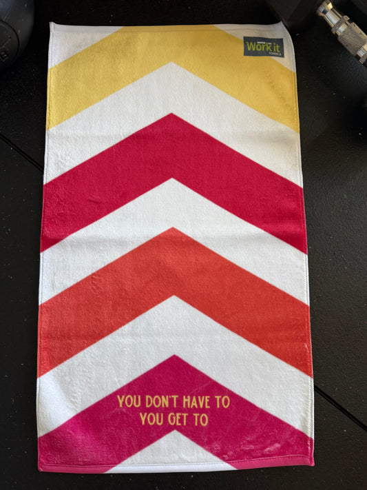 Striped towel with chevron pattern and text on a dark surface