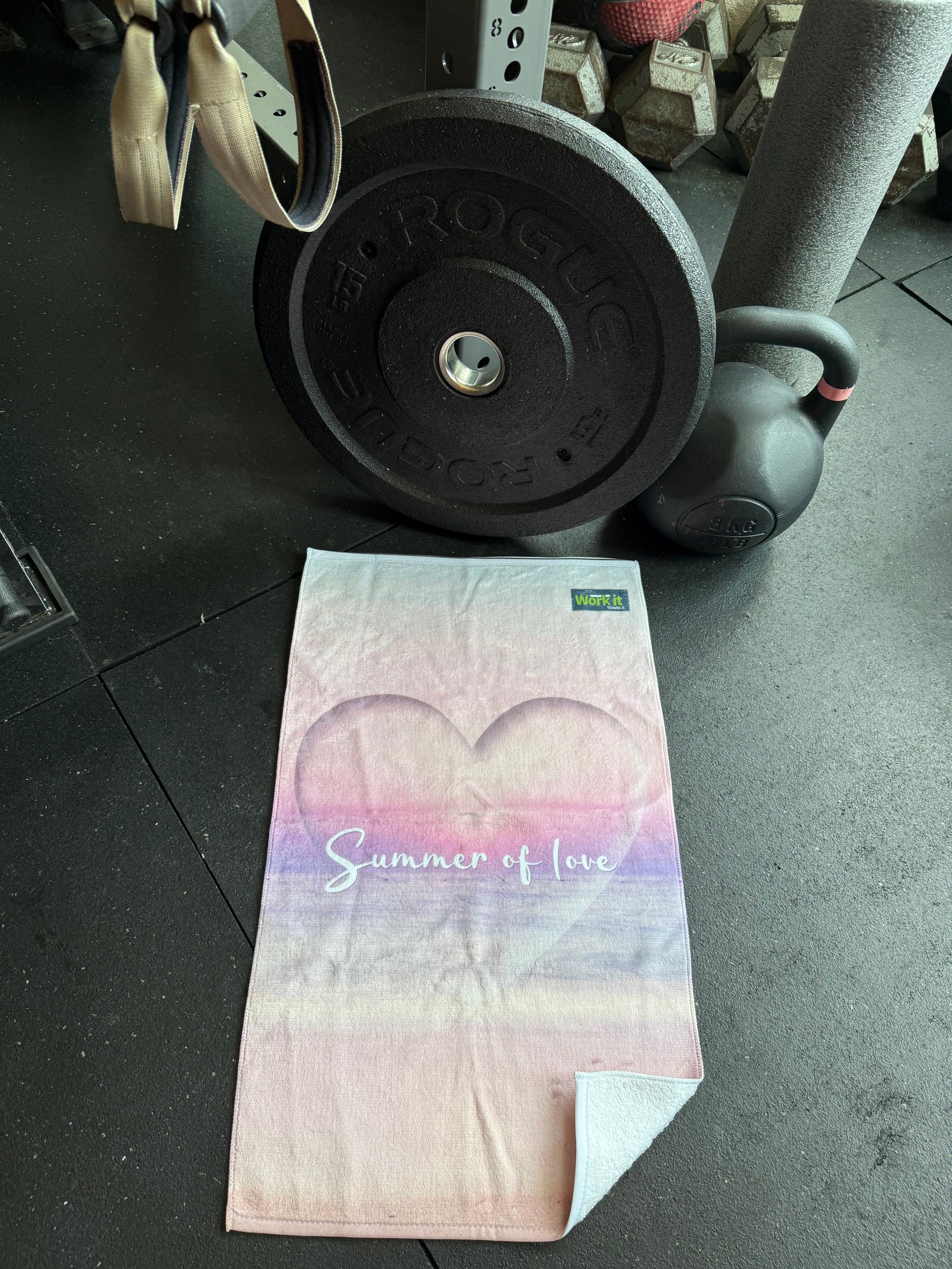 Gym towel with floral design on a gym floor next to weights for summer reality tv lovers