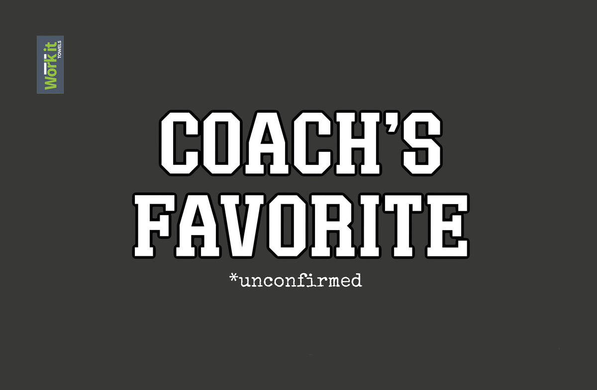 dark grey towel design with white font that says 'coach's favorite *unconfirmed' 