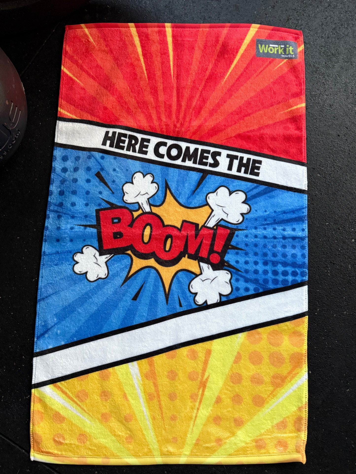 Colorful fabric with comic book-style design featuring the word 'BOOM!' on a black background.