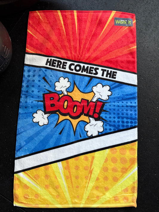 Colorful fabric with comic book-style design featuring the word 'BOOM!' on a black background.