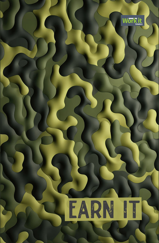 Green and olive camouflage patterned gym towel with bold text reading 'earn it' in a distressed lettering and Work It Towels logo in the top right corner