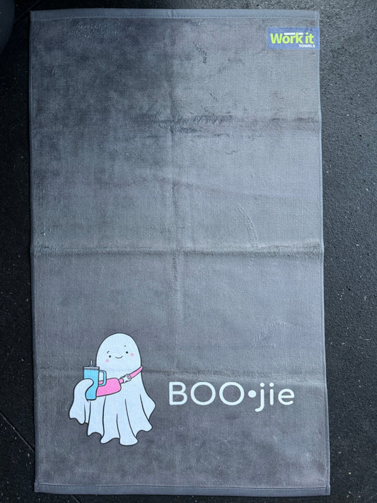 Gray towel with a cartoon ghost and 'BOO•jie' text on a dark background