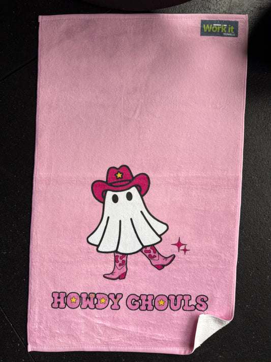 Pink towel with a cartoon ghost cowgirl character and 'Howdy Ghoul' text on a black background