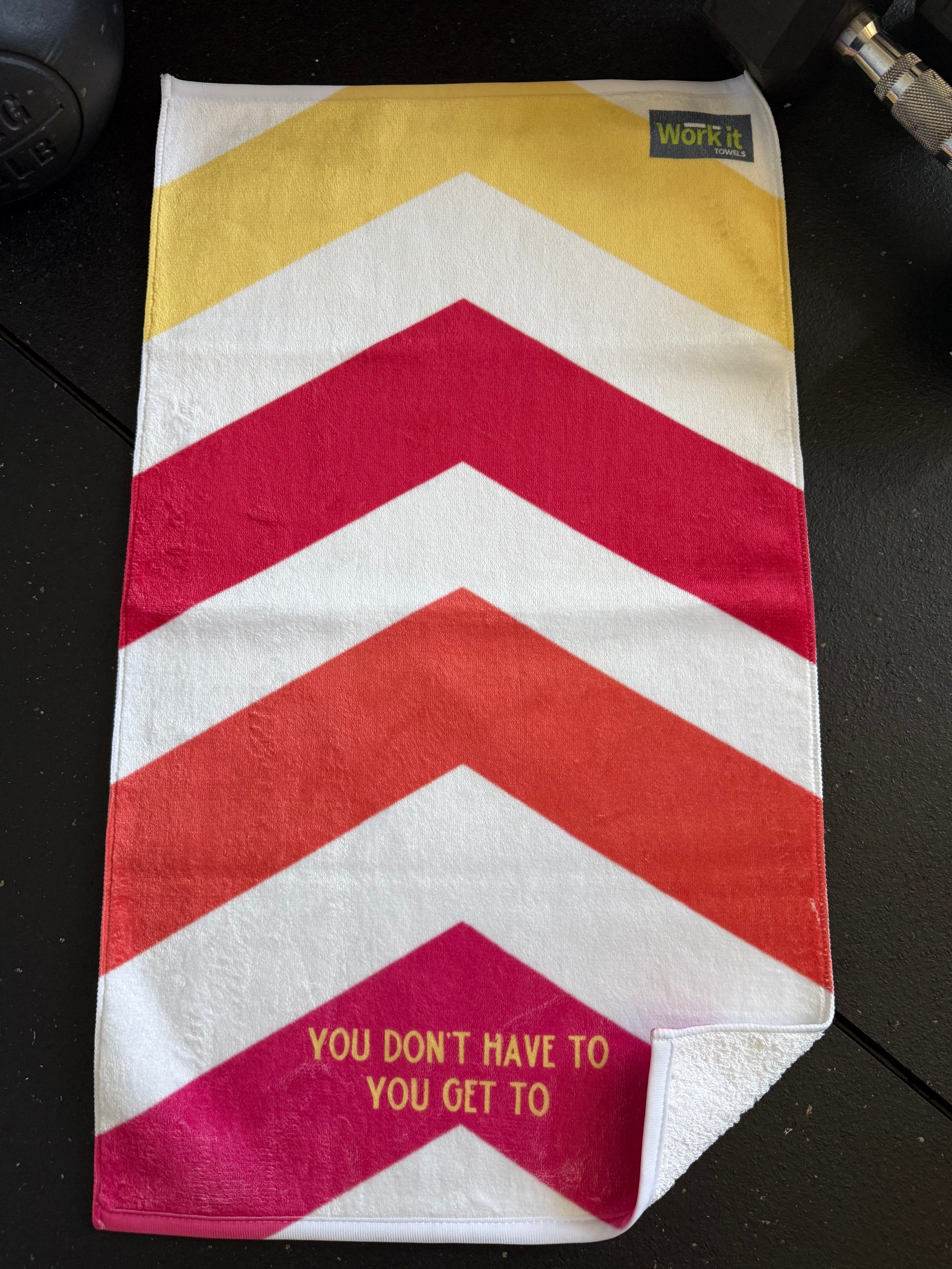 Striped towel with chevron pattern and text on a black surface