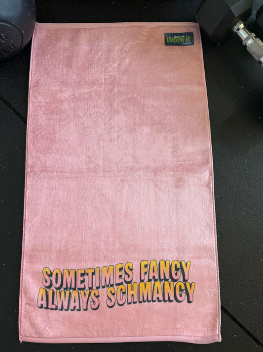 Pink towel with text on a black surface