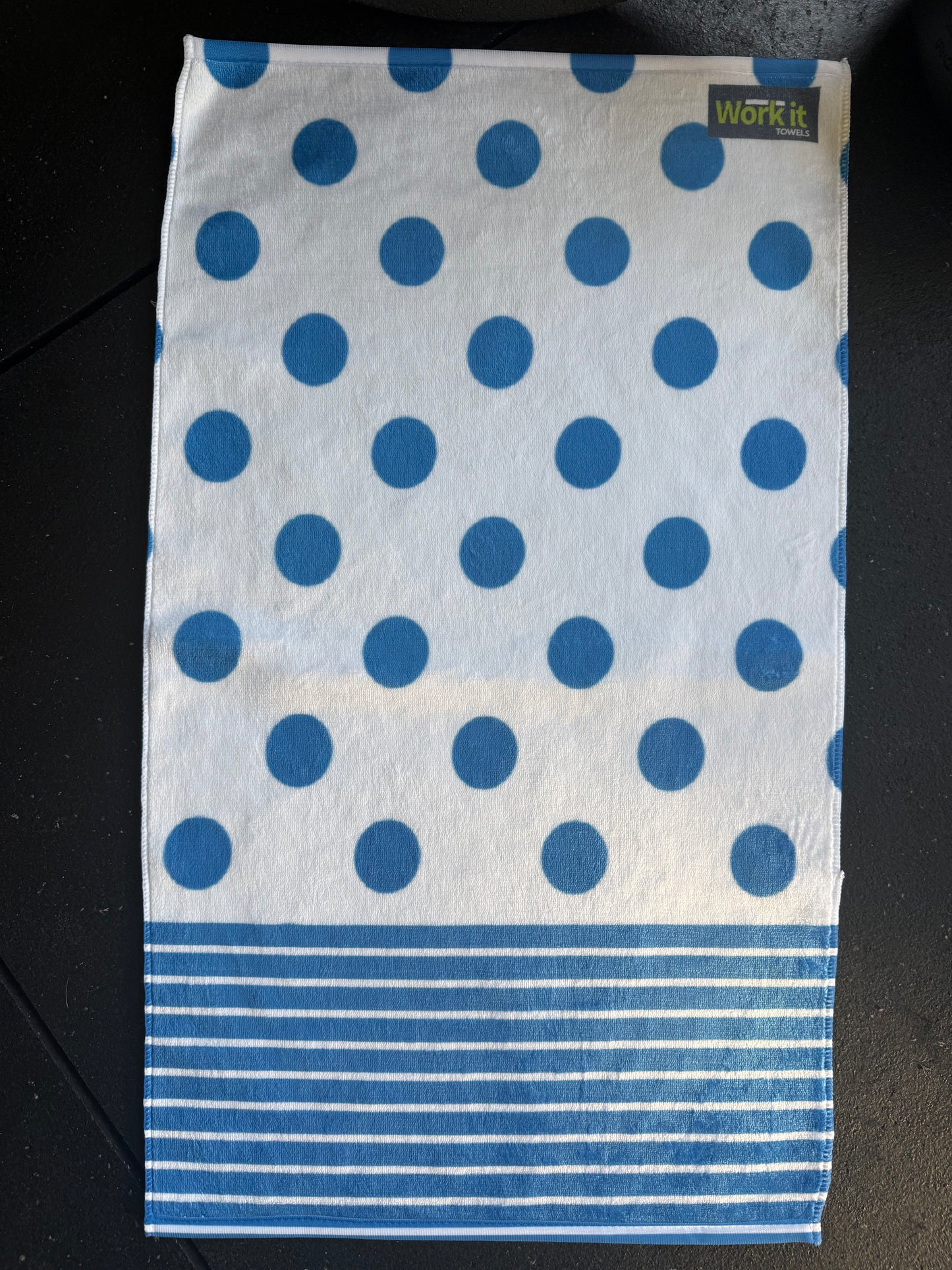 Towel with blue polka dots and stripes on a black background