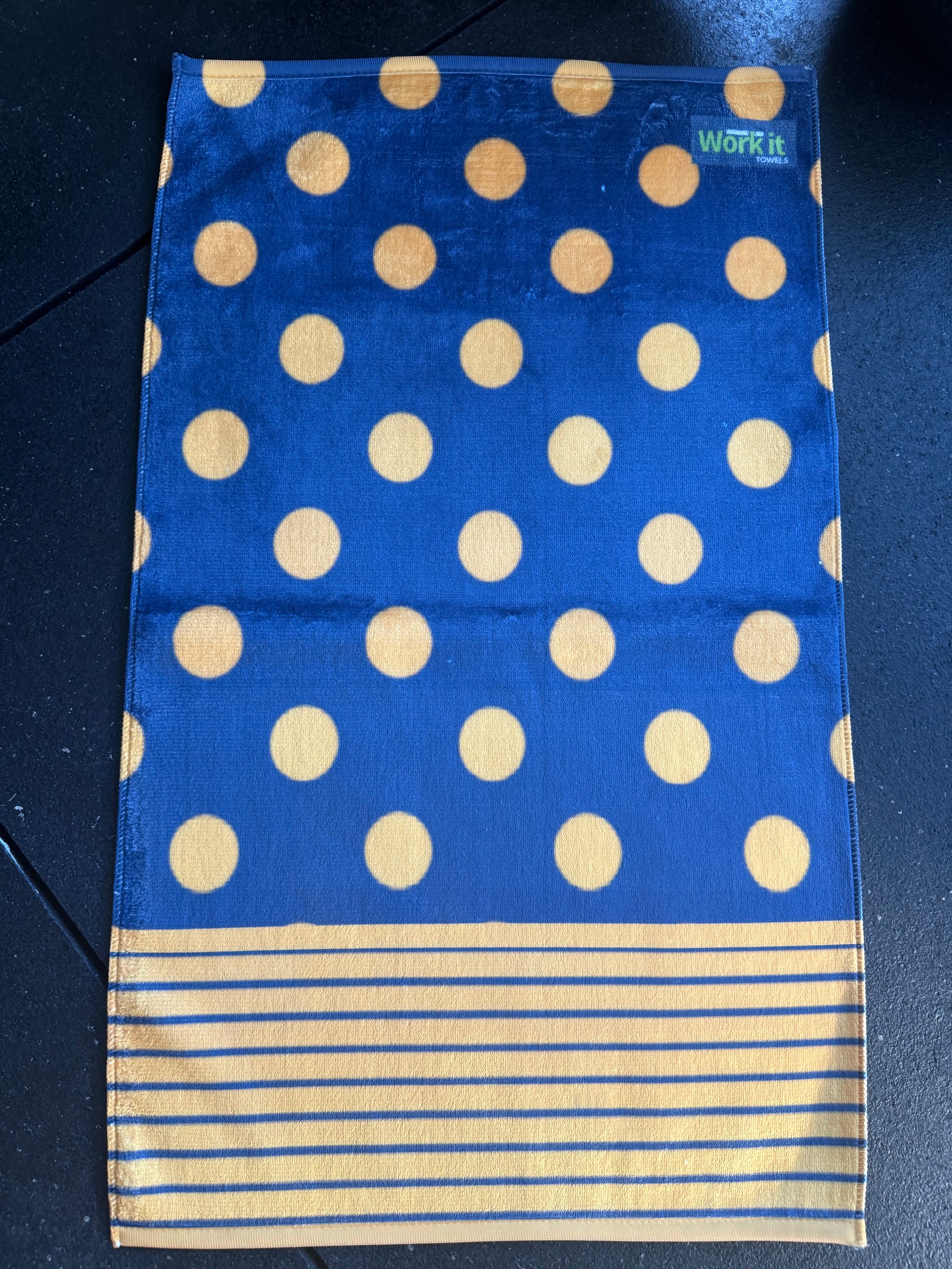 Blue fabric with gold polka dots and gold stripes on a dark background