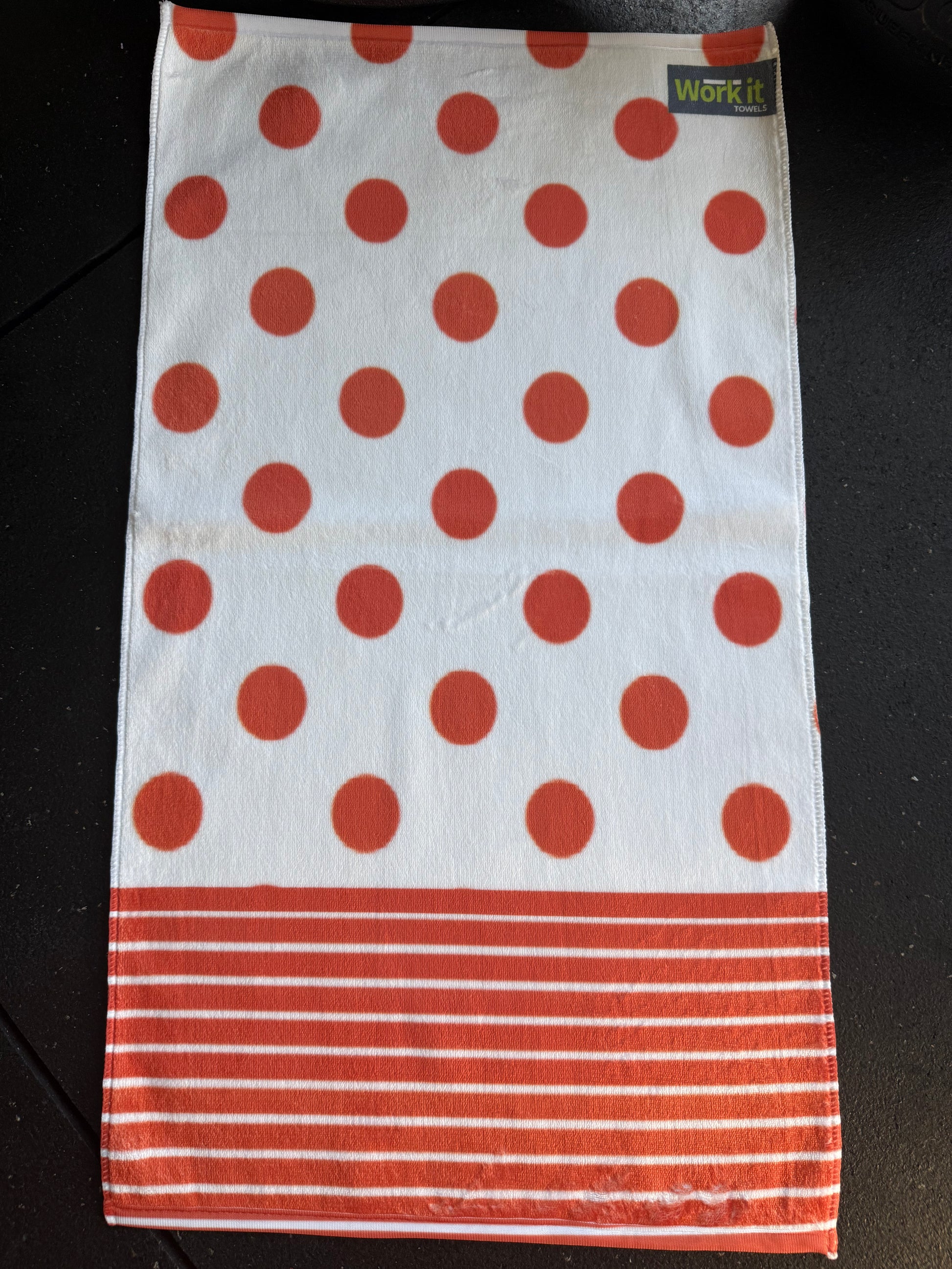 Towel with red polka dots and stripes on a white background
