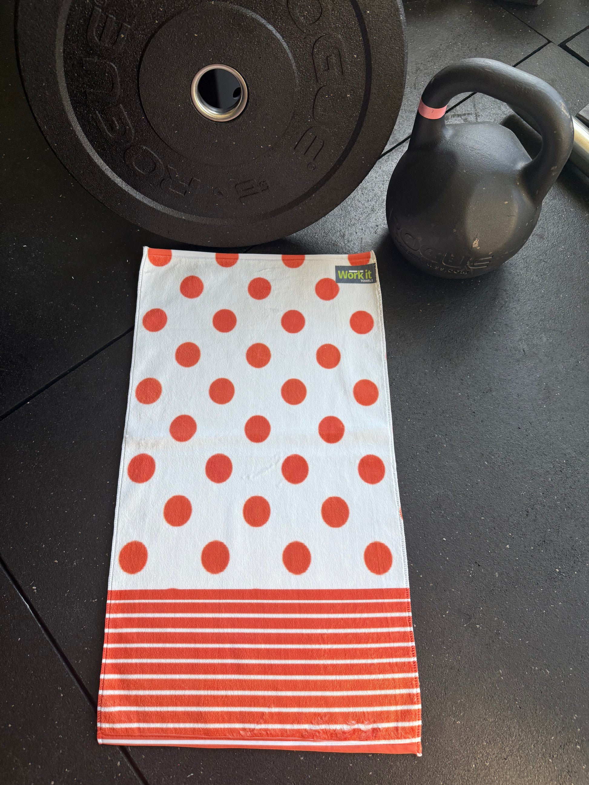 Polka dot towel on a gym floor with weights in the background