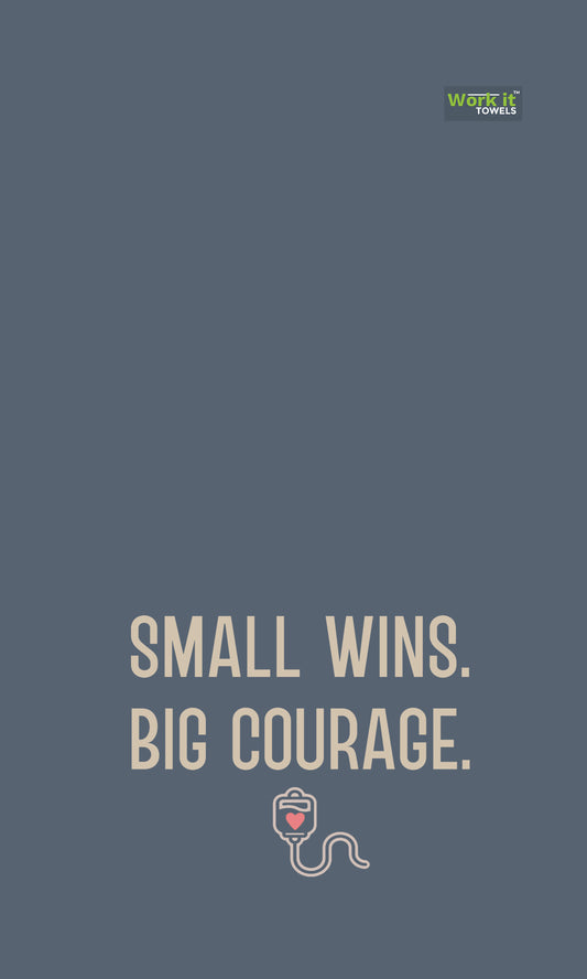 blueish grey towel design with text, 'small wins, big courage,' and a small IV graphic with a heart 
