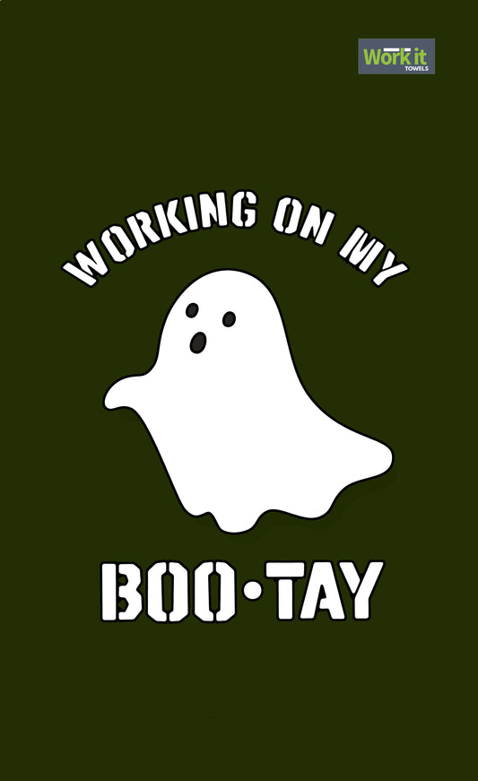 A green gym towel with a white graphic of a boo-tay (ghost) and the text 'Working on my BOO-TAY'.